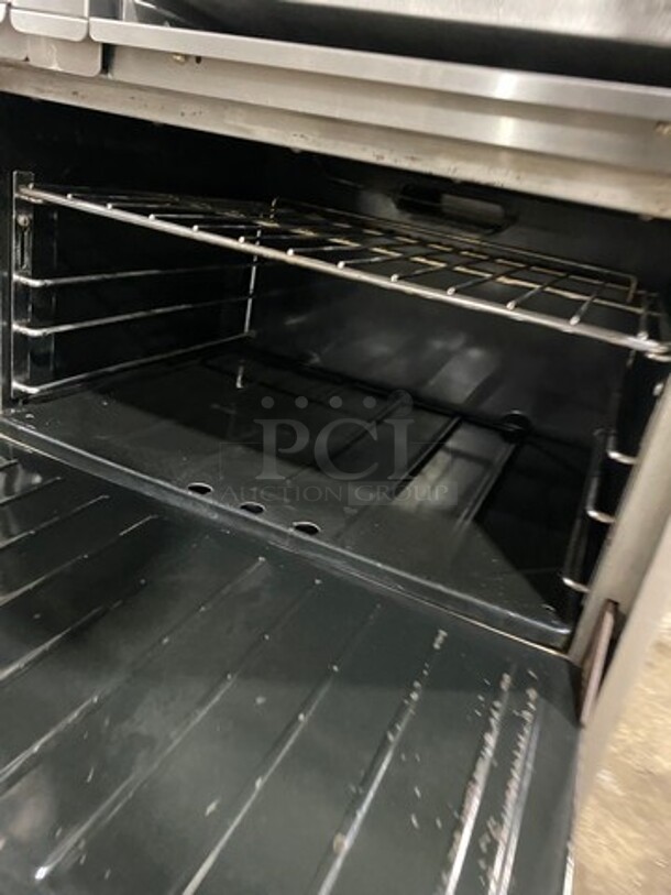 GREAT FIND! Garland Commercial Gas Powered 6 Burner Stove With Right Side Flat Griddle! Griddle Has Side Splashes! With Raised Back Splash And Salamander Shelf! With 2 Oven Underneath! Metal Oven Racks! All Stainless Steel! On Casters! - Image 6 of 11