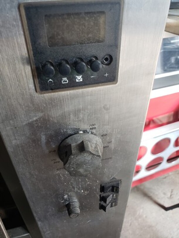 Hickory 10.10E Electric Rotisserie Oven on Casters! Left side of the oven has a small dent. Missing one knob and one knob is broken and needs to be replaced. 

Motor 120V, 1PH
Heating Elements 208V, 3PH - Image 9 of 10
