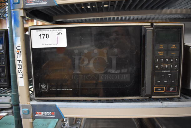 General Electric J E48 003 Metal Countertop Microwave Oven. 120 Volts, 1 Phase. 18x13x9.5