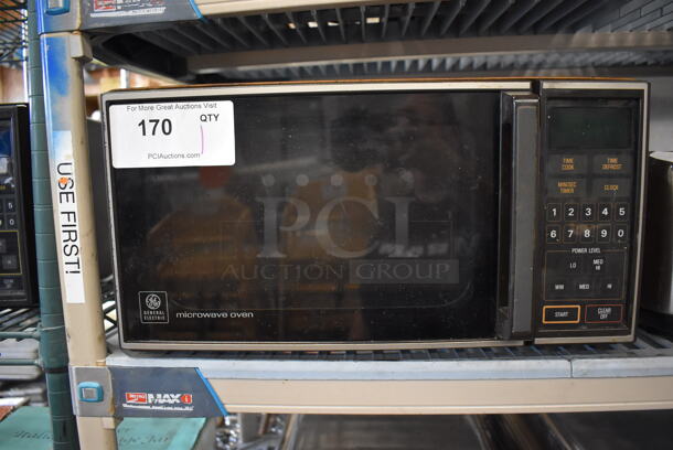 General Electric J E48 003 Metal Countertop Microwave Oven. 120 Volts, 1 Phase. 18x13x9.5 - Image 1 of 5