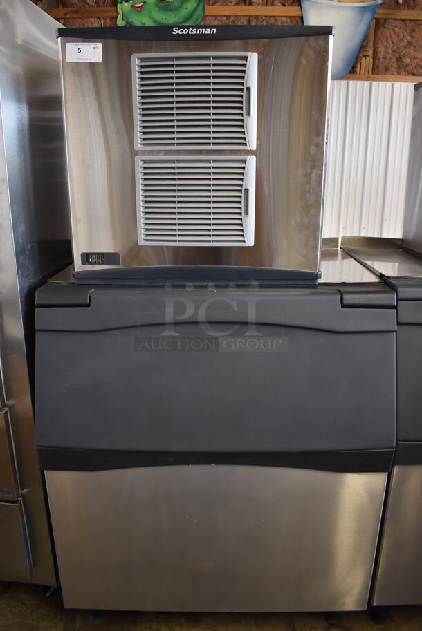 BRAND NEW! 2022 Scotsman C1030MA-32F Commercial Stainless Steel Ice Cube Machine With Storage Bin, Ice Scooper And Additional Parts On Black Legs. 208/230V, 1 Phase. Tested And Working!  - Image 1 of 11