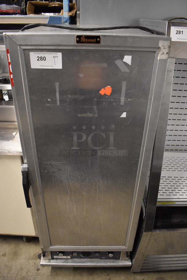 2020 Lockwood H-HEAT UNIT-EXT-6 CA55-PFIN-26ID-R Metal Commercial Single Door Heated Holding Cabinet w/ 7 Metal Full Size Baking Pans on Commercial Casters. 120 Volts, 1 Phase. 21x31x56. Tested and Does Not Power On