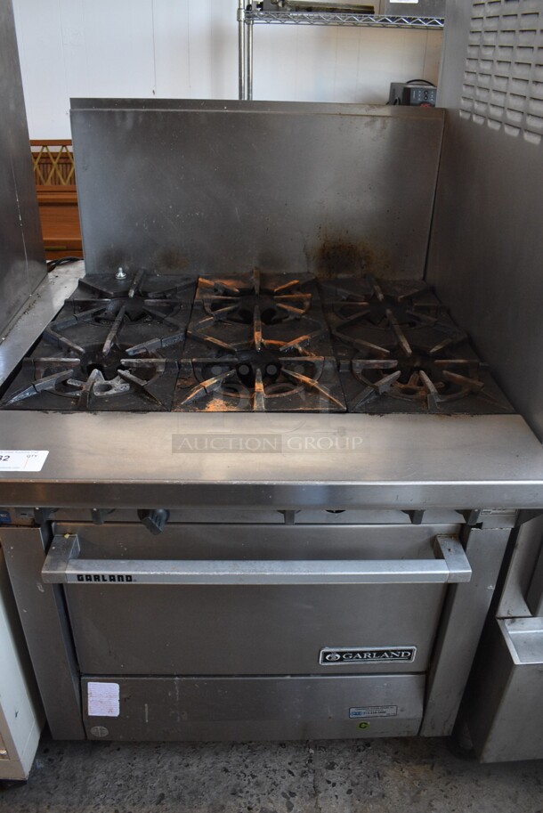 Garland Model M43R Stainless Steel Commercial Natural Gas Powered 6 Burner Range w/ Oven and Backsplash on Commercial Casters. 34x38x51.5