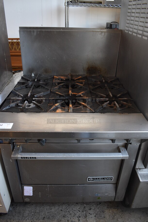 Garland Model M43R Stainless Steel Commercial Natural Gas Powered 6 Burner Range w/ Oven and Backsplash on Commercial Casters. 34x38x51.5 - Image 1 of 7