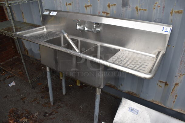 Stainless Steel 3 Bay Sink w/ Dual Drain Boards and Handles. One Leg Needs to Be Reattached. 60x19x43. Bays 10x14x10. Drain Board 11x16x1