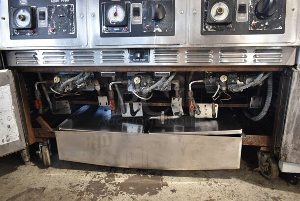 Henny Penny CG-303 Stainless Steel Commercial Floor Style  Natural Gas Powered 3 Bay Deep Fat Fryer w/ 3 Lids and 4 Metal Fry Baskets on Commercial Casters. 240,000 BTU. - Image 4 of 10