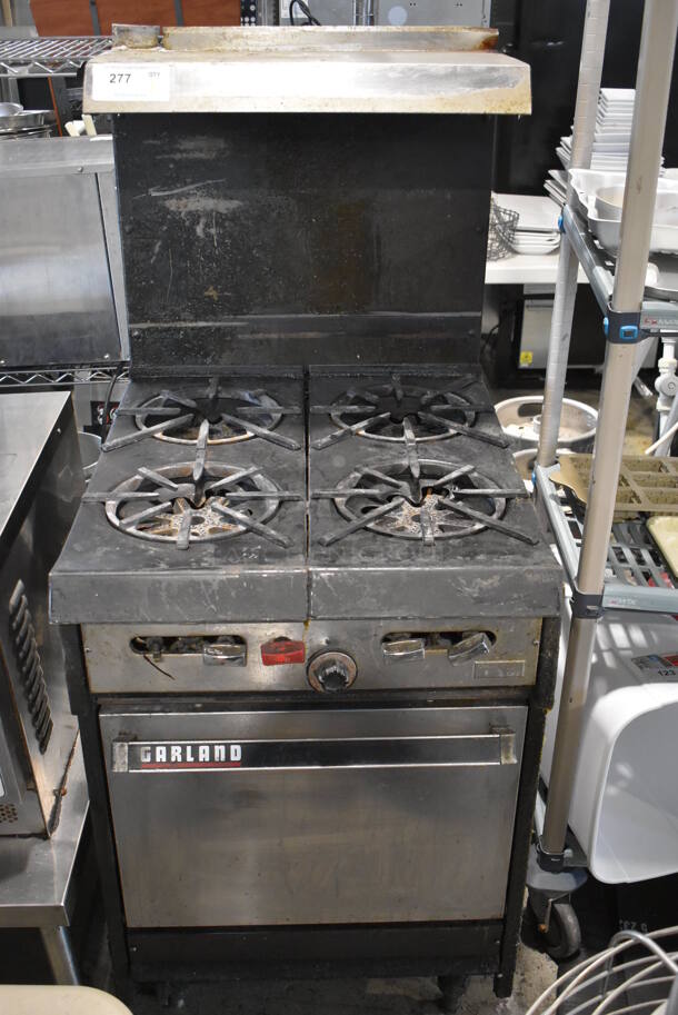 Garland Metal Commercial Natural Gas Powered 4 Burner Range w/ Oven, Over Shelf and Back Splash.