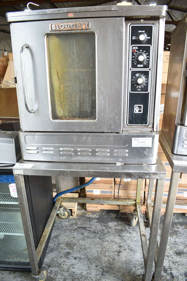 Blodgett Stainless Steel Commercial Natural Gas Powered Half Size Convection Oven w/ View Through Door, Metal Oven Racks, Thermostatic Controls and Equipment Stand on Commercial Casters.  - Image 1 of 7