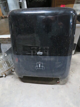 One Tork Paper Towel Dispenser.