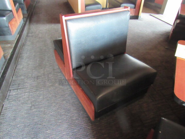 One Double Sided Wooden Booth With A Black Cushioned Seat And Back. 29X46X36