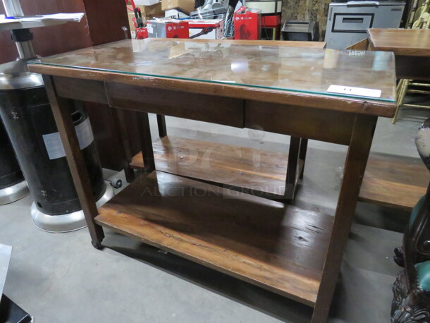 One Wooden Table With Undershelf, Drawer, And Glass Top,  On Casters. 43.5X20.5X35