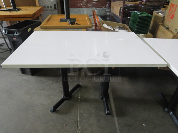 One White Laminate Table Top On A Dual Pedestal Base. 42X30X30