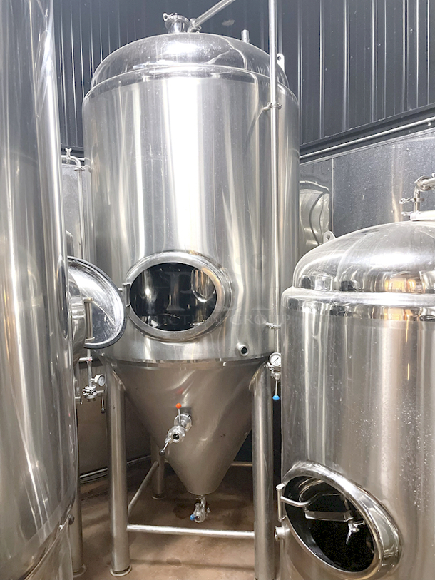 ? ? BEAUTIFUL!! Stout Tanks & Kettles - 15 BBL Fermenter / Unitank (Jacketed). ? ? Features: Easily Converts to a Unitank or Brite Serving Tank; Glycol Jacketed - 2 Zones: Cone and Sidewall; Shadowless Manway for Easy Cleaning; Adjustable Racking Arm for Clear Transfer; 1.5" Sample Valve for Quality Testing; Back Mounted Pressure Gauge; Adjustable Feet for Leveling on Uneven Floors or Fine Height Adjustments; Pressure Gauge Type: Back Mount; CIP Arm and 2.5" Rotating CIP Spray Ball; 2 Butterfly Valves; Rated to 2-Bar (29 PSI); 1/2" NPT Welded Thermowell for Contactless Temperature Probe Tank Thickness: 3mm Jacket and Outer Shell Thickness: 2mm. Cone: 60 degree Interior Angle. 51.5-in. diameter x 125-in.H. - Image 2 of 4