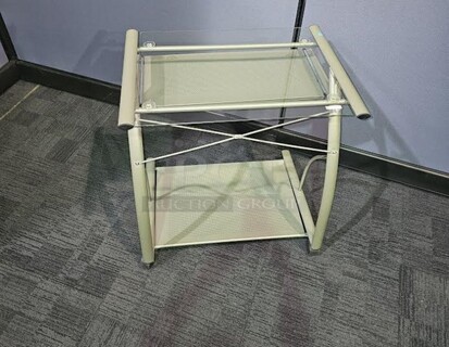 Metal silver rolling small desk with glass top. In good condition! Minor wear and scratches but cleans up very nicely and is fully functional. 27” W x 29” H x 19” D. 