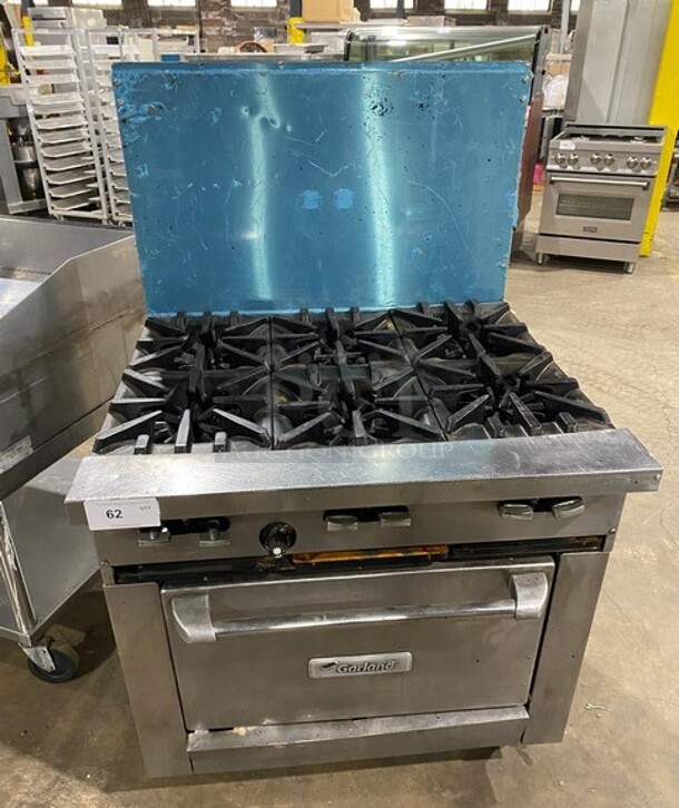 Garland Commercial Natural Gas Powered 6 Burner Stove! With Raised Back Splash! With Oven Underneath! Metal Oven Rack! All Stainless Steel! On Casters!