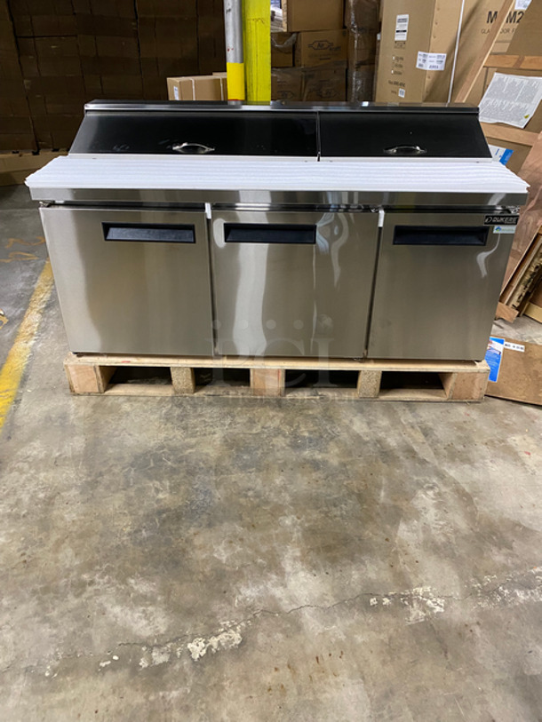SCRATCH & DENT! Dukers Commercial Refrigerated Sandwich Prep Table! With Commercial Cutting Board! With 3 Door Storage Space Underneath! Poly Coated Racks! Solid Stainless Steel! Powers On, Doesn't Go Down To Temp! Model: DSP72 115V 60HZ 1 Phase