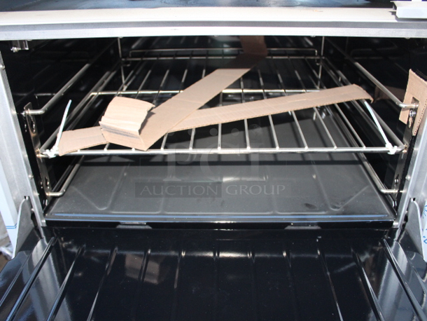 BRAND NEW SCRATCH & DENT! Garland G60-4G36RR Natural Gas 4 Burner 60" Range with 36" Griddle and 2 Standard Ovens - 262,000 BTU. S/N: 2310100102544 Rail holding burners is bent, Splash Guard is bent, 1 knob not connected. (see photos)	 - Image 5 of 9