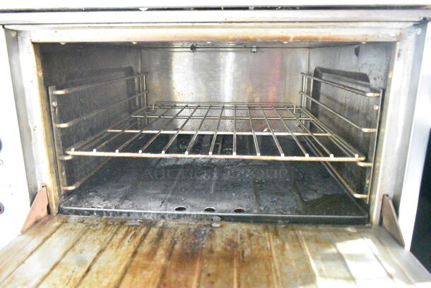 US Range C836-7 Stainless Steel Commercial Natural Gas Powered 4 Burner Range w/ Oven and Back Splash on Commercial Casters.  - Image 6 of 9