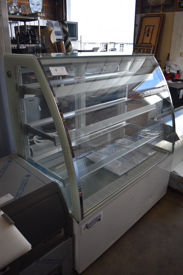 BRAND NEW SCRATCH AND DENT! Avantco 193BCTD48W Stainless Steel Commercial Floor Style 3-Shelf Curved Glass Dry Bakery Display Case w/ LED Lighting on Commercial Casters. 110-120 Volts, 1 Phase. Tested and Working! - Image 1 of 7