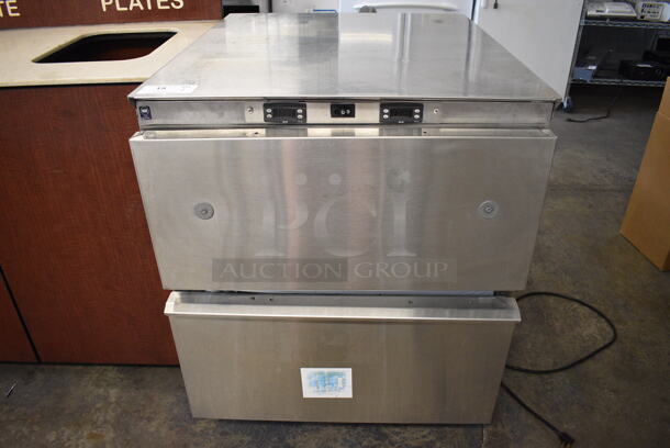 Stainless Steel Commercial 2 Drawer Undercounter Cooler and Freezer Combo Unit on Commercial Casters. 30x37x38.5. Tested and Powers On But Cooler Temps at 52 Degrees and Freezer Temps at 32 Degrees