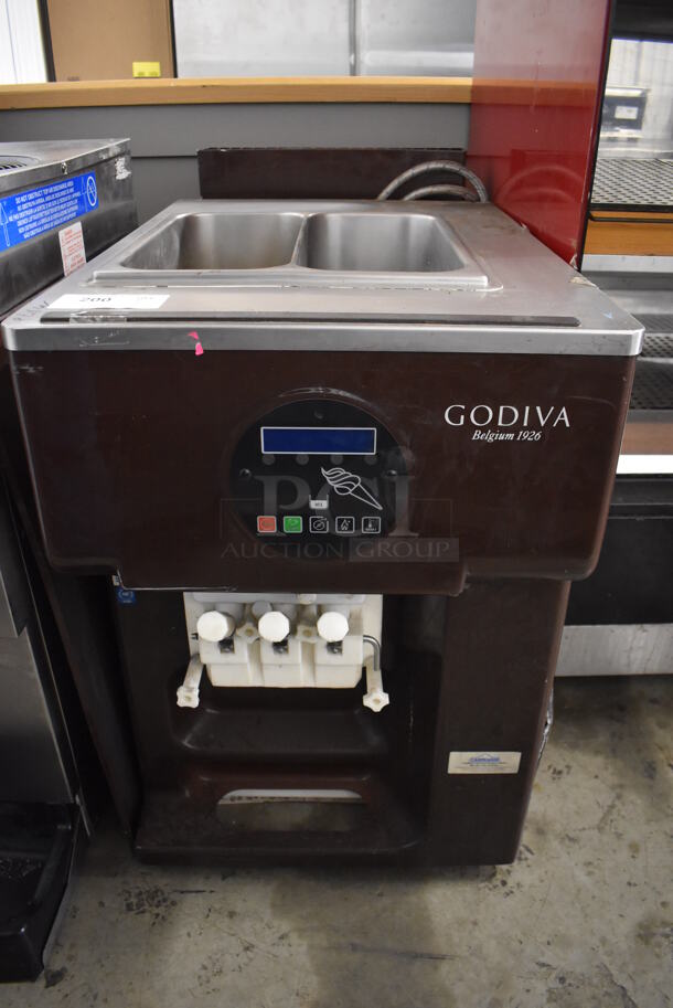 Godiva Stainless Steel Commercial Countertop Air Cooled 2 Flavor w/ Twist Soft Serve Ice Cream Machine. 208-230 Volts, 3 Phase. 21.5x35x36