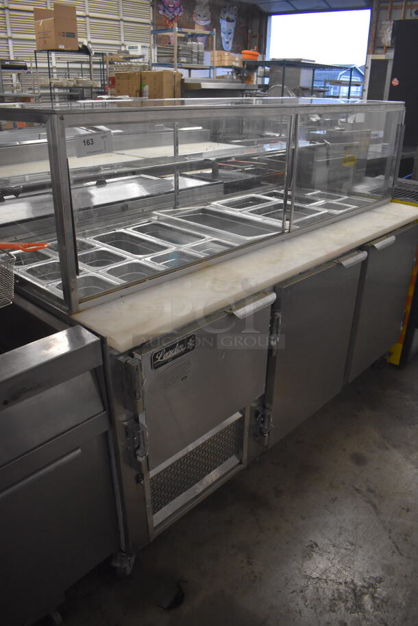 Leader Stainless Steel Commercial Prep Table w/ Glass Sneeze Guard, Various Drop In Bins on Commercial Casters. 115 Volts, 1 Phase. 72x33x55. Tested and Does Not Power On