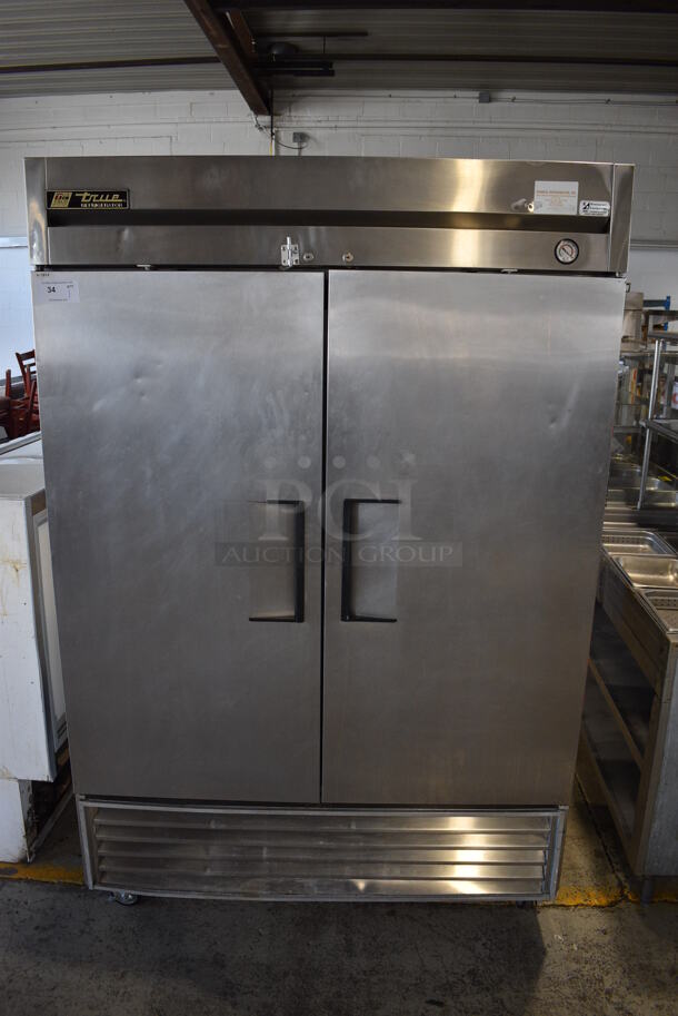 True Model T-49 Stainless Steel Commercial 2 Door Reach In Cooler w/ Poly Coated Shelves on Commercial Casters. 115 Volts, 1 Phase. 54x30x83. Tested and Working!