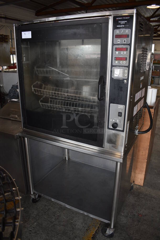 Henny Penny Model SCR-8 Stainless Steel Commercial Electric Powered 8 Spit Rotisserie Oven on Stainless Steel Table w/ Commercial Casters. 208 Volts, 3 Phase. 40x34x74