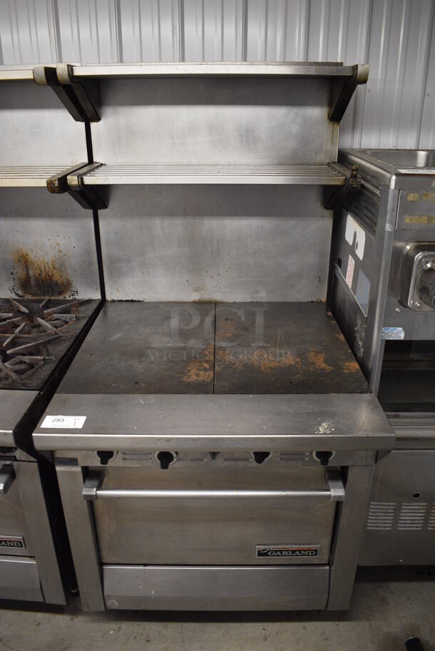 Garland Model M46R Stainless Steel Commercial Natural Gas Powered Flat Top w/ Oven, 2 Over Shelves and Back Splash on Commercial Casters. 34x38x69
