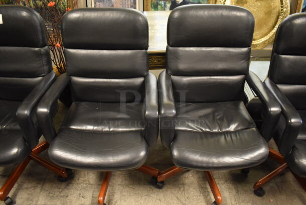4 Black Office Chairs w/ Arm Rests on Casters. 4 Times Your Bid!