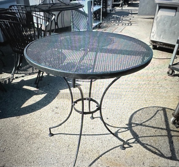 One Black Metal Round Patio Table With Umbrella Hole. 28X32 - Image 1 of 1