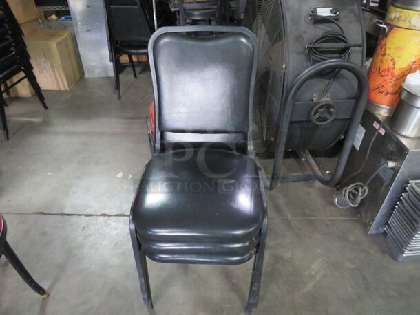 Black Metal Stack Chair With Black Cushioned Seat And Back. 4XBID - Image 1 of 1