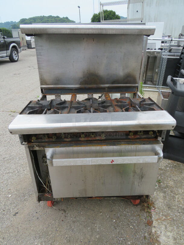One 6 Burner Natural Gas Range With 2 Racks And SS Over Shelf, On Casters. Missing 3 Burner Rings. Missing Left Side And Bottom Panel.  36X32.5X56.5 - Image 1 of 1