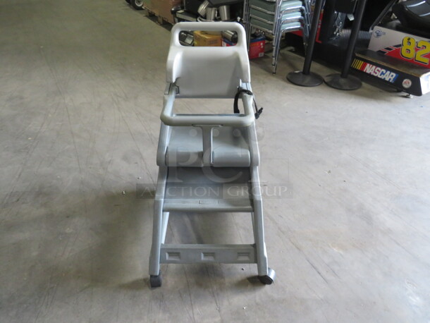One Gray Poly High Chair With Safety Straps, On Casters.