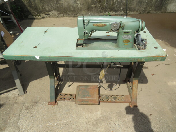One Consew Sewing Machine on A Table.#102.  48X20X30