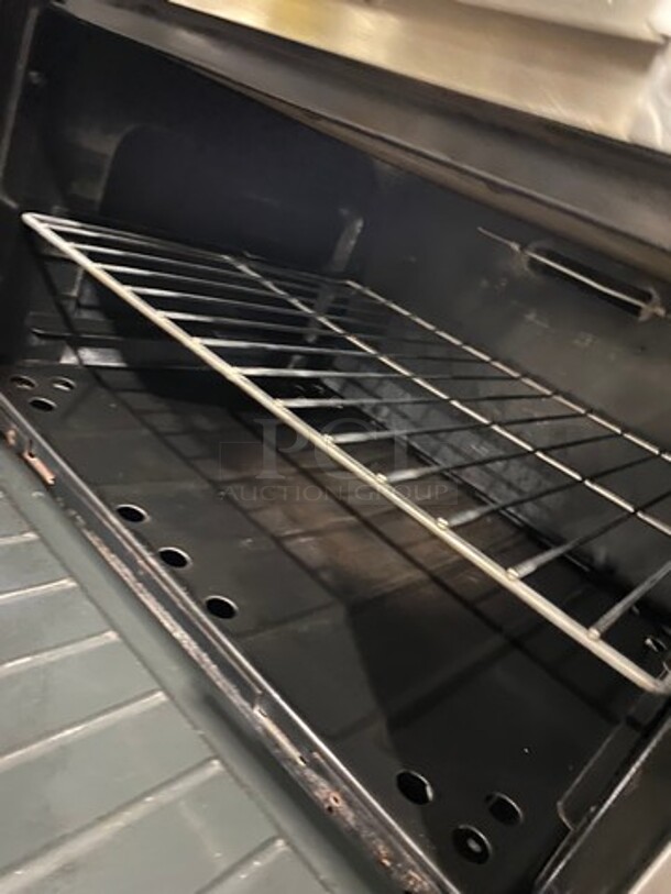 GREAT FIND! Garland Commercial Gas Powered 6 Burner Stove With Right Side Flat Griddle! Griddle Has Side Splashes! With Raised Back Splash And Salamander Shelf! With 2 Oven Underneath! Metal Oven Racks! All Stainless Steel! On Casters! Working When Removed! - Image 10 of 12