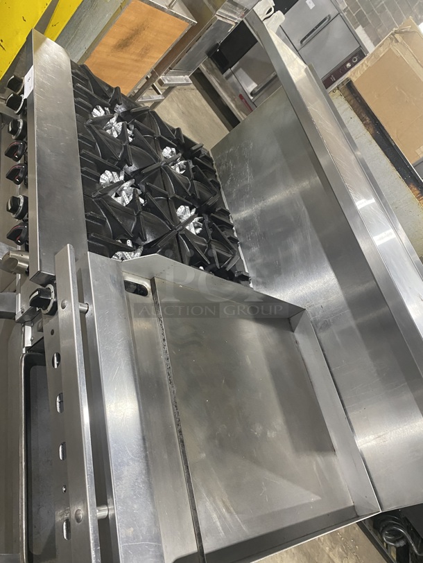 BEAUTIFUL! GARLAND All Stainless Steel Natural Gas Powered 6 Burner Range W/ Raised Right Side Flat Top W/ Cheese Melter! With 2 Ovens W/ Metal Racks! With Raised Over Back Splash & Slamander Shelf! On Commercial Casters! Working When Removed! - Image 5 of 9