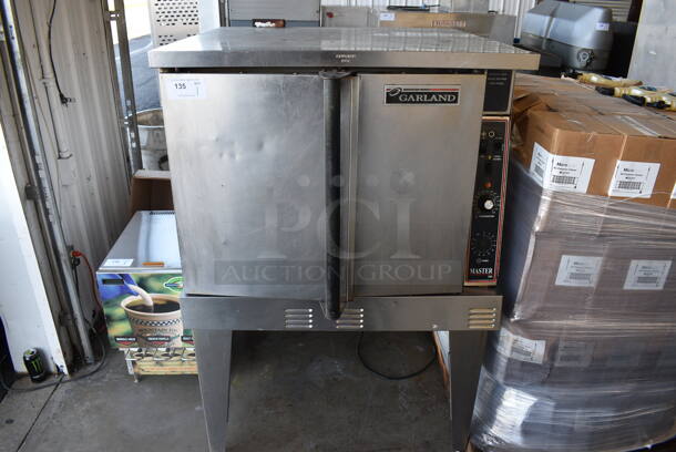 Garland Master 200 Stainless Steel Commercial Natural Gas Powered Full Size Convection Oven w/ Solid Doors, Metal Oven Racks and Thermostatic Controls on Metal Legs. 338x40x59