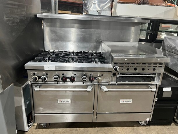 WOW! Garland Stainless Steel Commercial Natural Gas Powered! 6 Burner Range With Right Side Flat Top Griddle, 2 Ovens, Back Splash! On Casters! Working When Removed! MODEL GFE606R24RR SM:GFE606R24RR0009