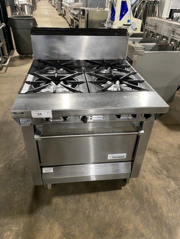 Garland Commercial Natural Gas Powered 4 Burner Stove! With Back Splash! With Oven Underneath! Metal Oven Rack! All Stainless Steel! On Casters! Model: M44R SN: 1601100100589