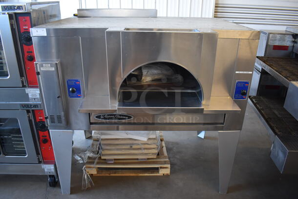 BRAND NEW! 2019 Bakers Pride FC-516 Stainless Steel Commercial Natural Gas Powered / Coal Burning / Wood Fired Il Forno Pizza Oven w/ Cooking Stones on Metal Legs. 140,000 BTU. 65.5x54x67 - Image 1 of 11