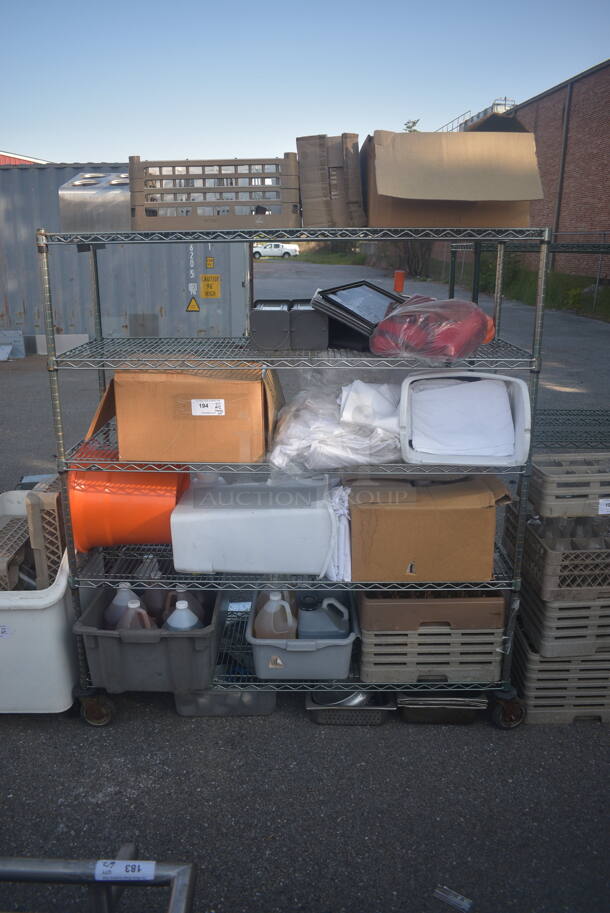 ALL ONE MONEY! Lot of Items Including Open Utility Shelf With Metro Style Shelving, Linens, Orange Salad Spinner With Lid, Trash Can, Dish Caddy, Picture Frames, Toilet Paper, Steel Baking Trays, Circular Steel Tins, AND MORE! BUYER MUST DISMANTLE. PCI CANNOT DISMANTLE FOR SHIPPING. PLEASE CONSIDER FREIGHT CHARGES.