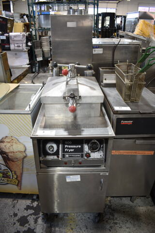 Henny Penny 500 Stainless Steel Commercial Floor Style Electric Powered Pressure Fryer w/ Metal Fry Basket on Commercial Casters. 208 Volts, 3 Phase. 