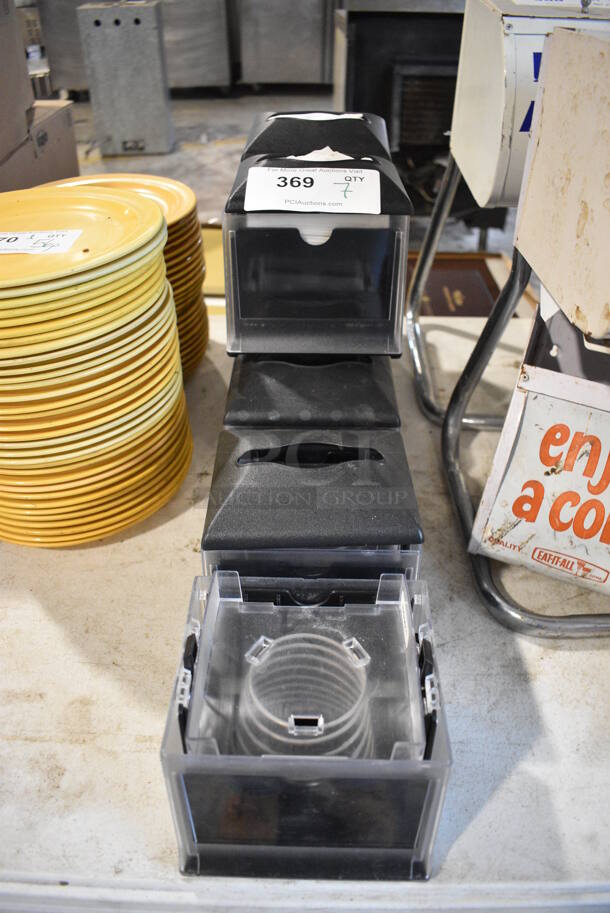 7 Black and Clear Poly Napkin Dispensers. 1 Missing Top. 6x6x6. 7 Times Your Bid! - Image 1 of 3