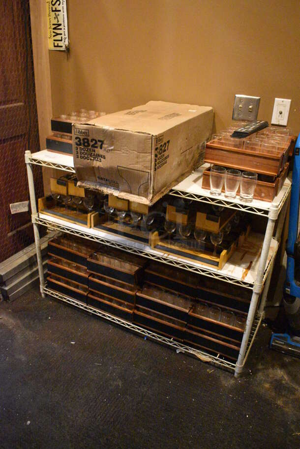 White Finish 3 Tier Wire Shelving Unit w/ Contents Including Wine Glasses. 48x18x36. BUYER MUST REMOVE; BUYER MUST DISMANTLE. PCI CANNOT DISMANTLE FOR SHIPPING. PLEASE CONSIDER FREIGHT CHARGES. (glass room - off of bar area) - Image 7 of 7