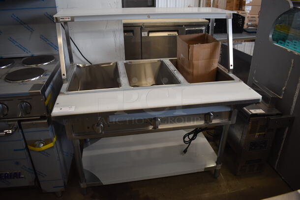 	BRAND NEW SCRATCH AND DENT! ServIt 423EST3WO Stainless Steel Commercial Electric Powered Three Pan Open Well Steam Table with Angled Sneeze Guard and Casters. 120 Volts, 1 Phase.