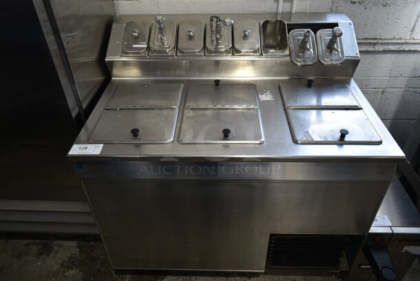 Stainless Steel Commercial Freezer w/ 3 Center Hinge Lids, 6 Drop Ins and 7 Lids on Commercial Casters. Tested and Working!