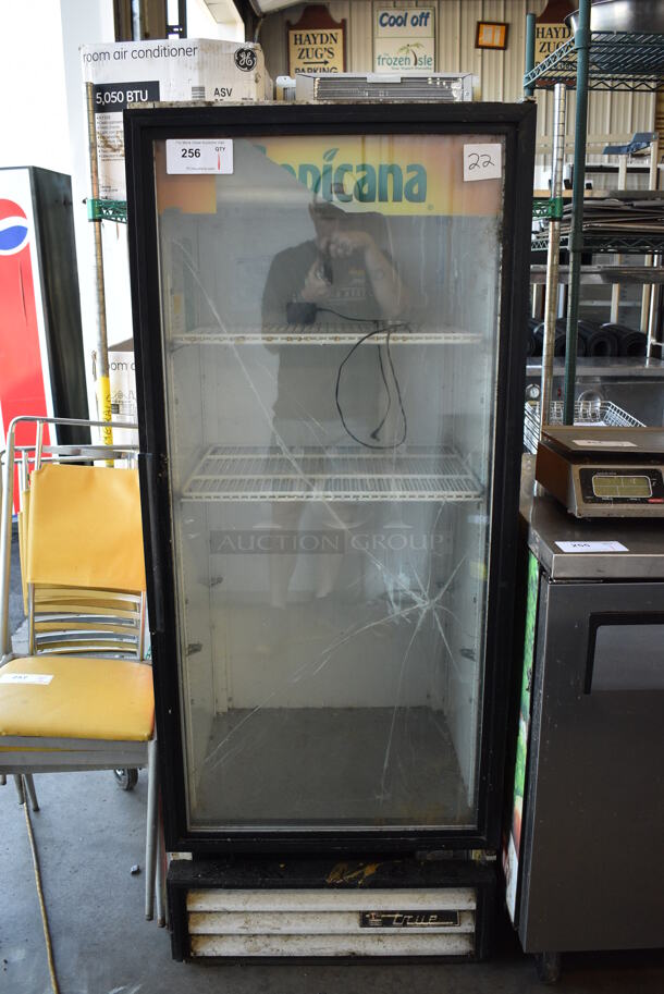 True Model GDM-12 Metal Commercial Single Door Reach In Cooler Merchandiser w/ Poly Coated Racks. See Pictures For Damage. 115 Volts, 1 Phase. 25x24x63. Tested and Working!