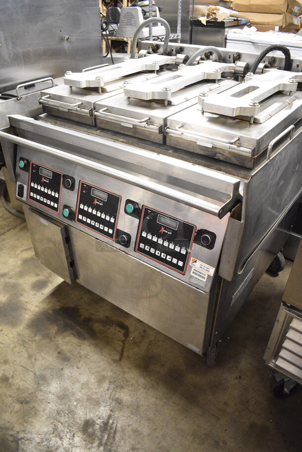 2015 Garland XG36 Stainless Steel Commercial Floor Style Natural Gas Powered  Xpress 36" Semi Automatic Triple Clamshell Grill Griddle on Commercial Casters.   - Image 2 of 12