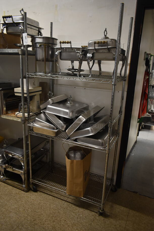 Chrome Finish 3 Tier Wire Shelving Unit w/ Contents Including Chafing Dishes. BUYER MUST REMOVE: BUYER MUST DISMANTLE. PCI CANNOT DISMANTLE FOR SHIPPING. PLEASE CONSIDER FREIGHT CHARGES. (hallway) - Image 1 of 4